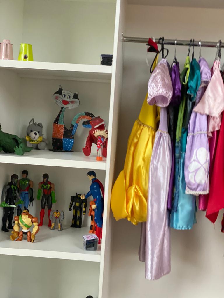 Canto do faz de conta com fantasias e brinquedos